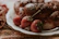 Close-up of natural fermented enzyme bread and colorful gelato scoops on a rustic plate.