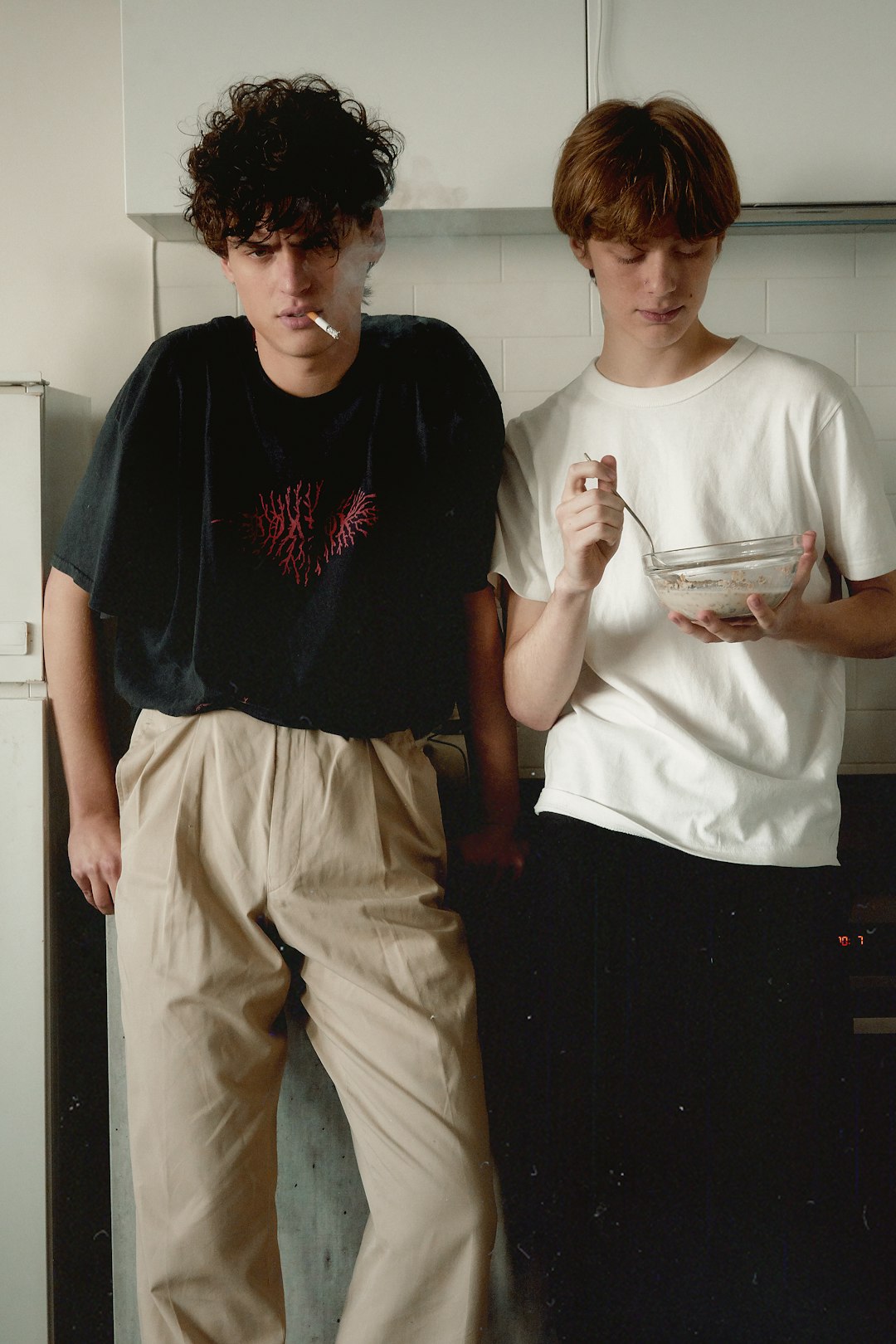 man standing beside man holding bowl and spoon