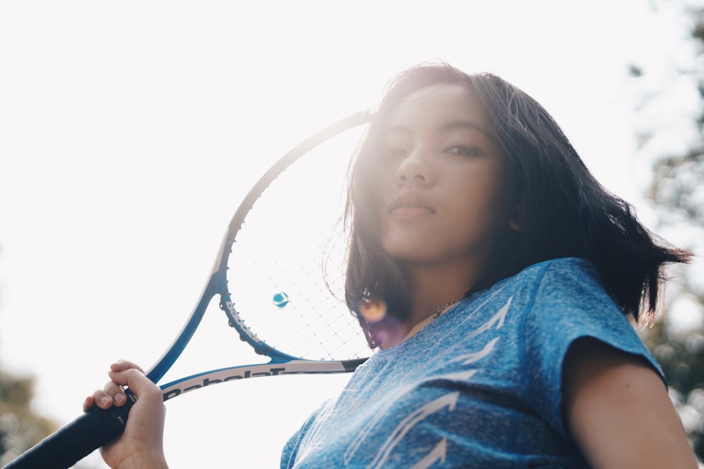 woman holding tennis racket