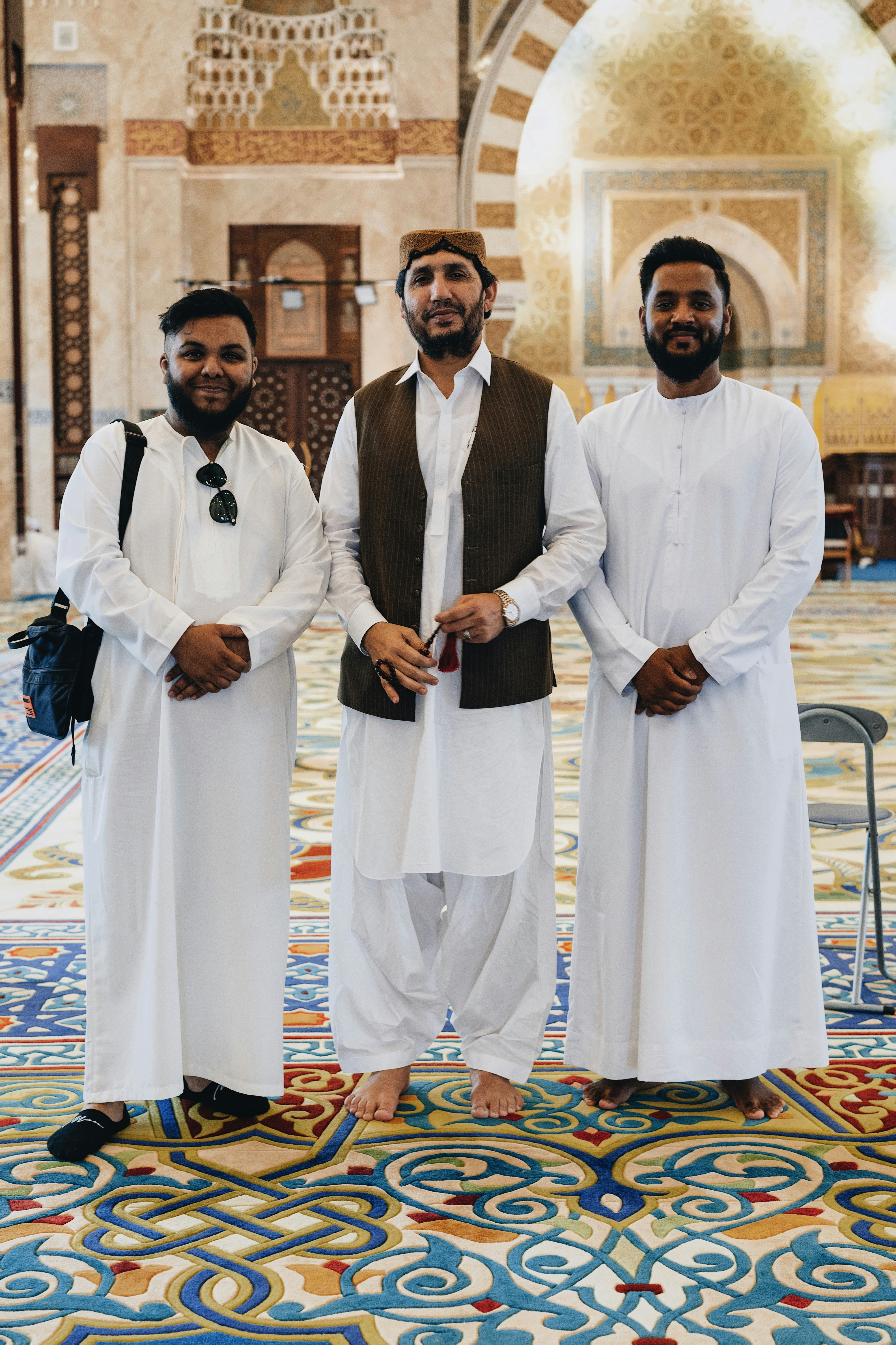 a group of three men standing next to each other
