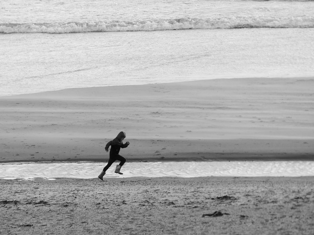 running person on seashore during daytime