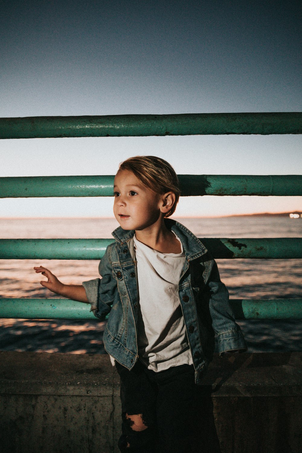 boy leaning on railing