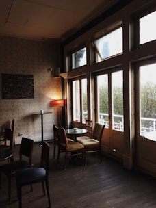 Cozy therapy room in a rustic brewery setting with natural light and calming decor.