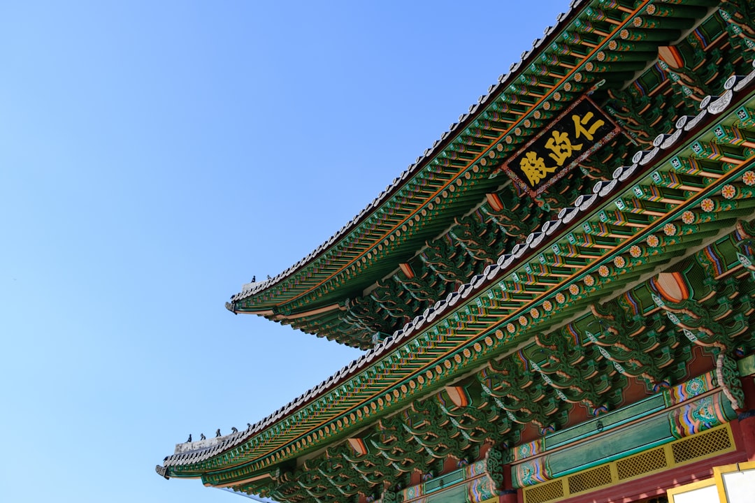 green and brown wooden gate with Kanji sign