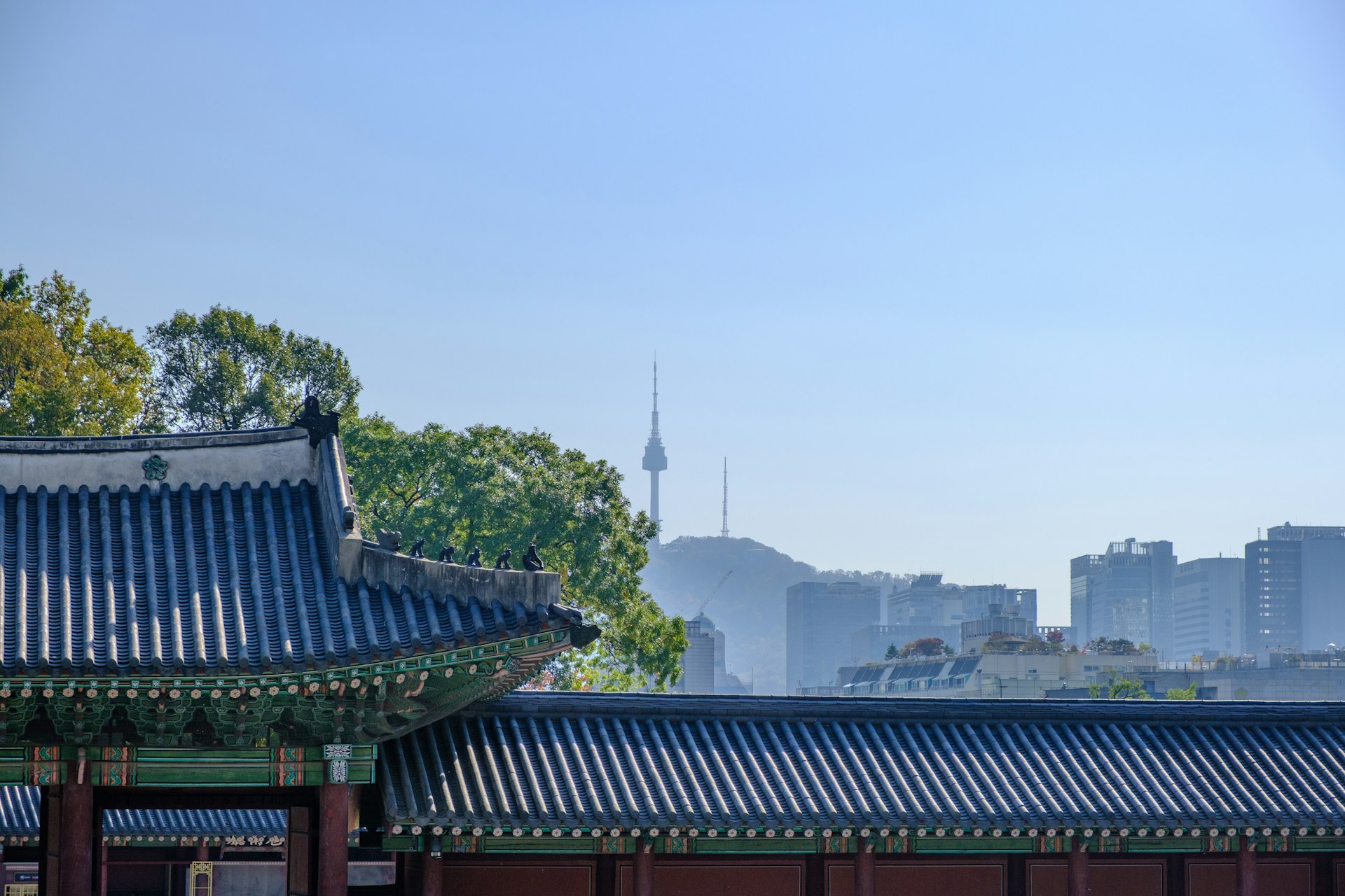 gray wooden temple beside green trees