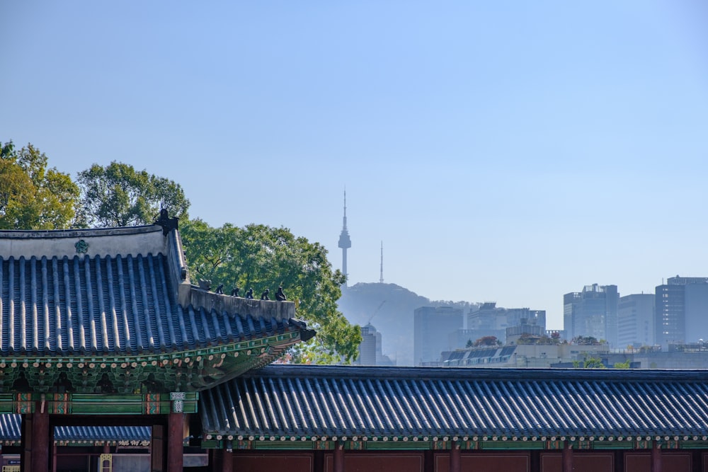 gray wooden temple beside green trees