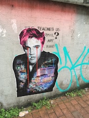 graffiti of man on gray concrete wall