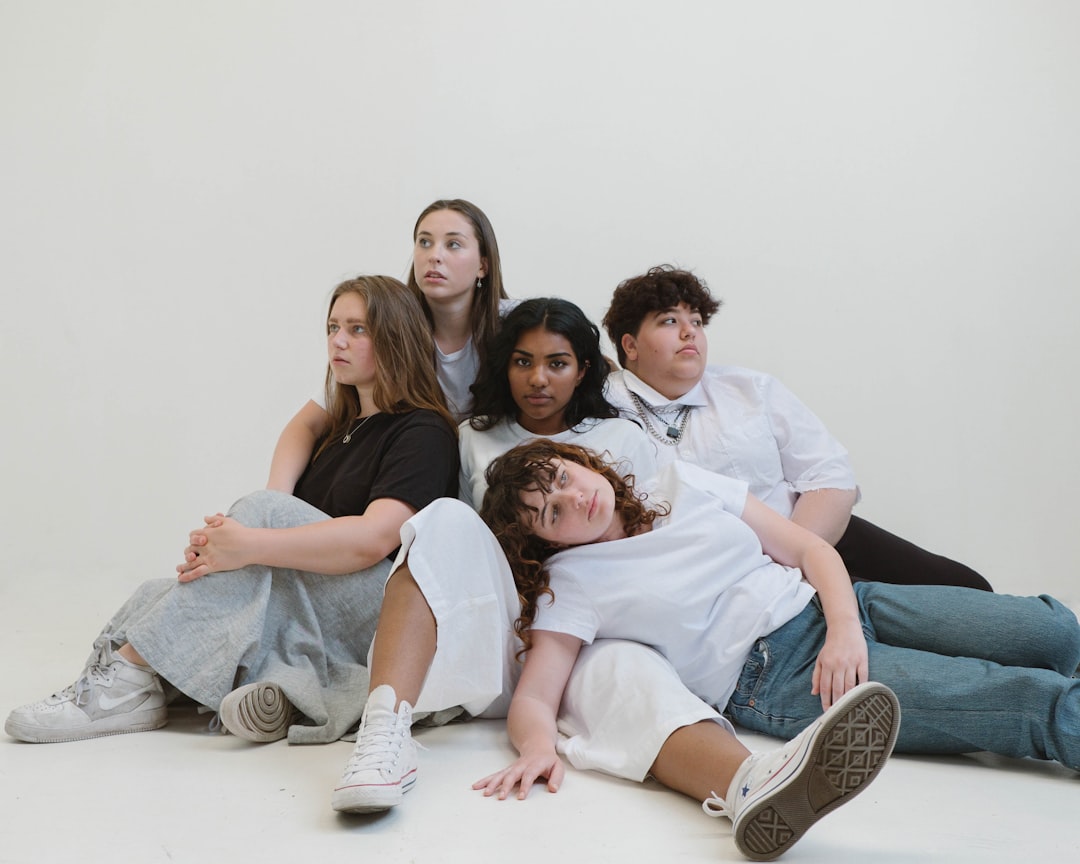 women and man sitting on floor