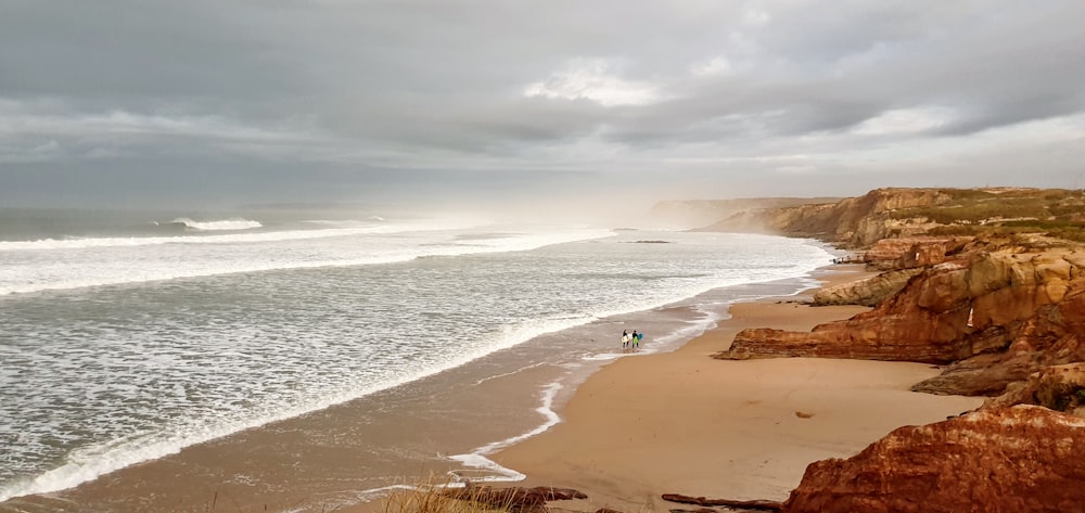 a view of a beach with waves coming in from the ocean