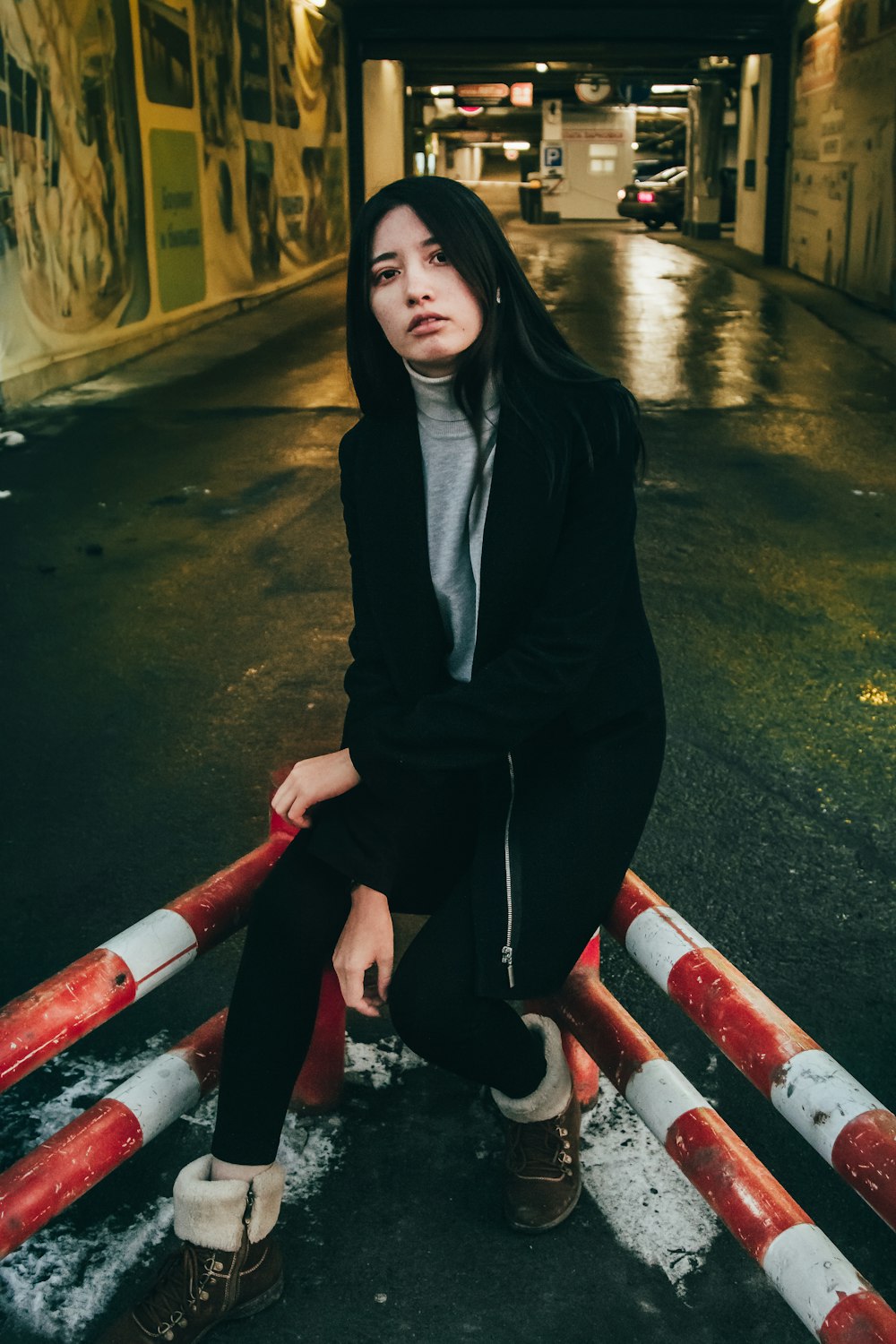 woman sitting on metal bar