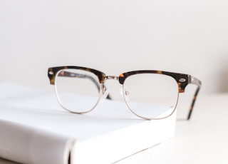 clear eyeglasses on book