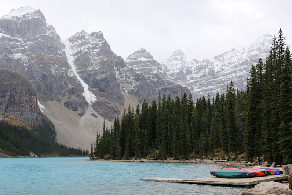 people near Moraine Lake in Canada viewing mountain under white sky