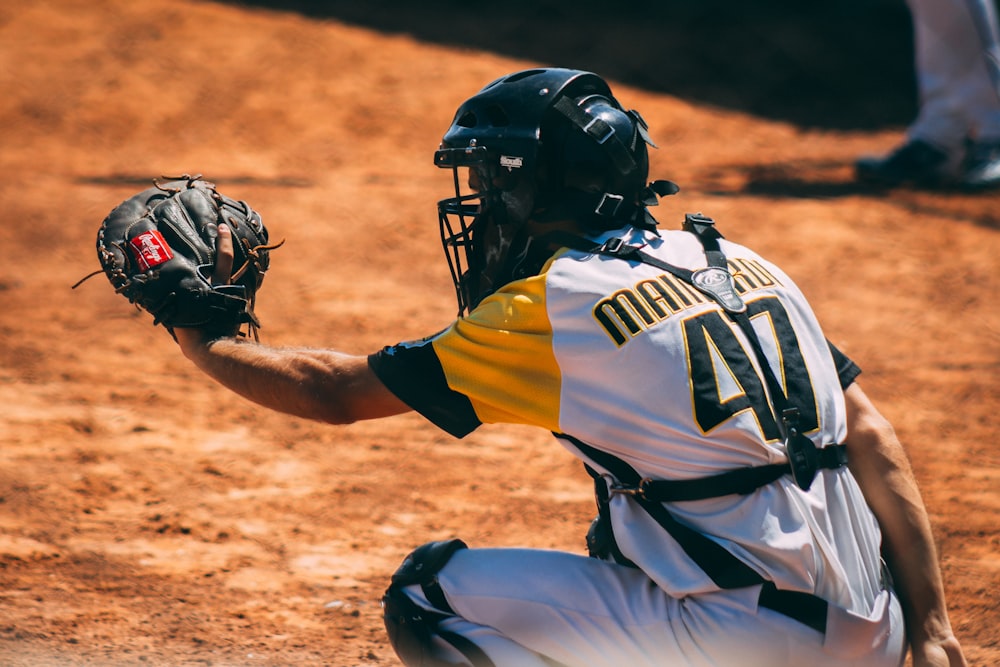 man sitting and about to catch ball