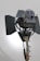 A large professional film or photography studio light with adjustable barn doors and a sturdy metal stand. The light source appears to be positioned against a plain background with soft illumination.