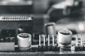 Close-up black-and-white shot of circuit boards and system design schematics.