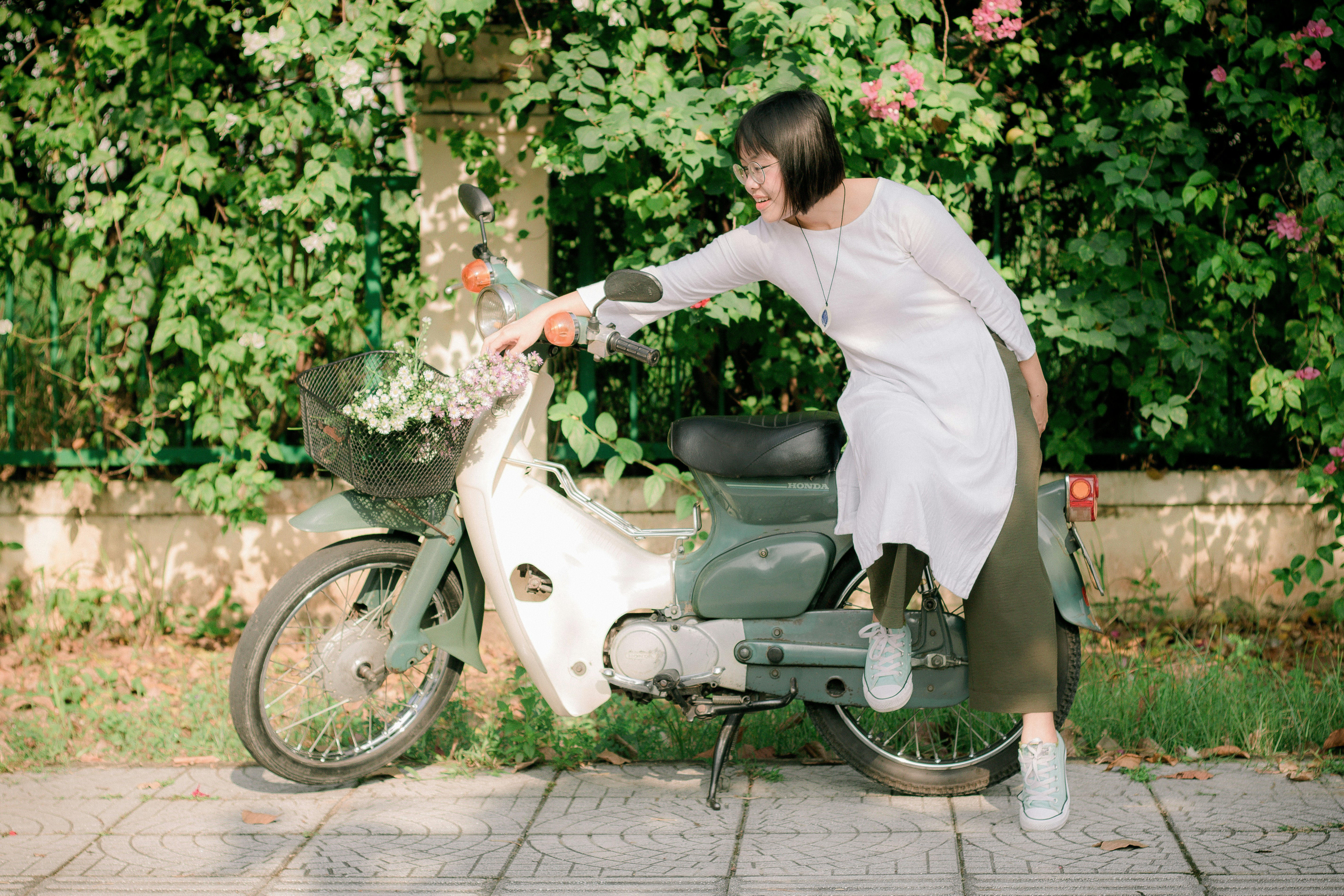 woman standing beside motorcycle