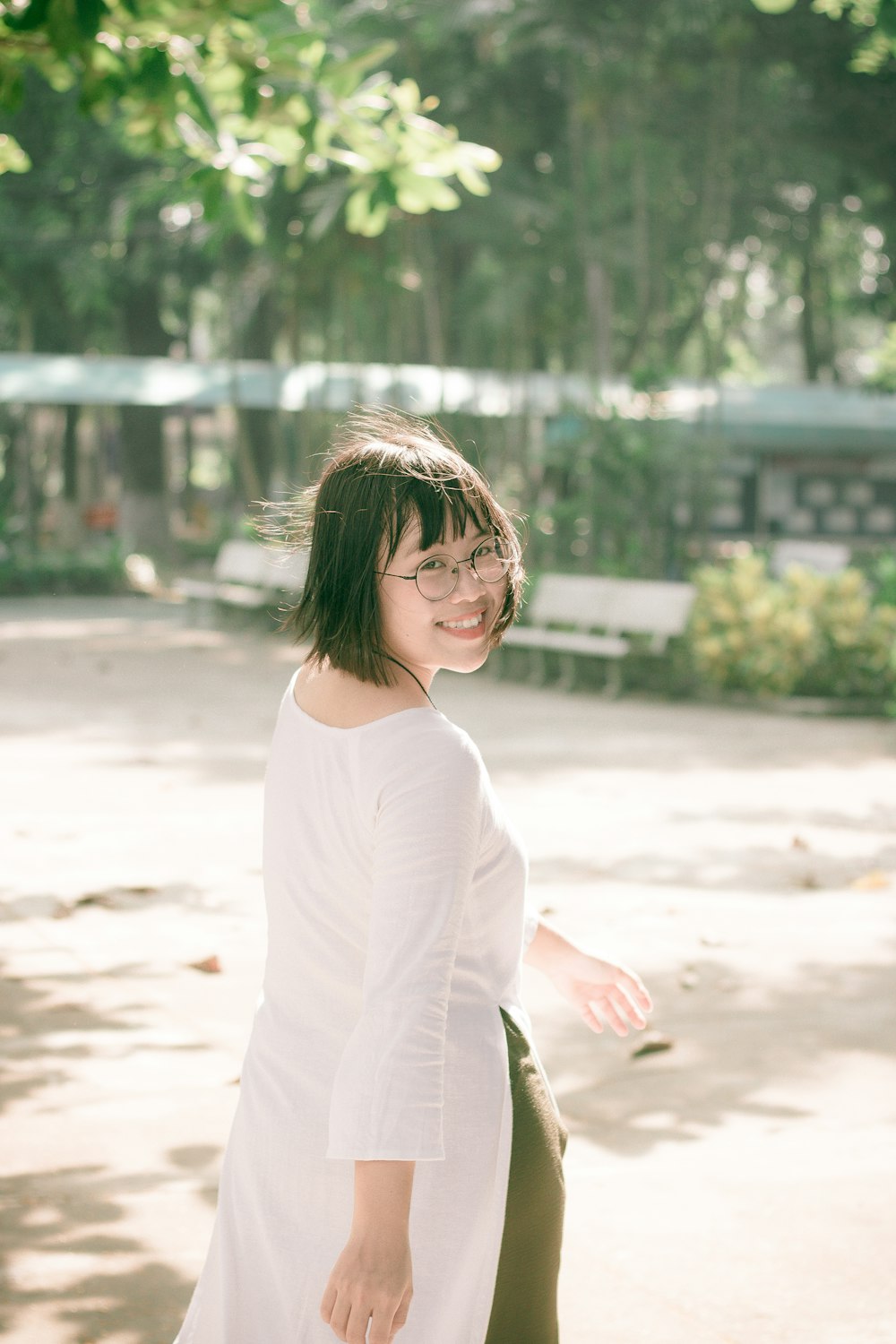 woman walking on road near bench