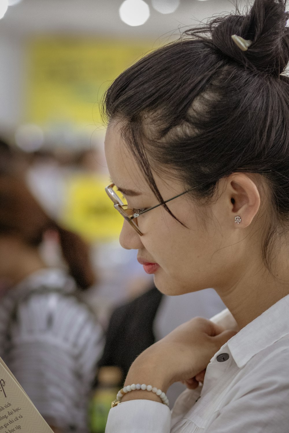 woman wearing white top and eyeglasses