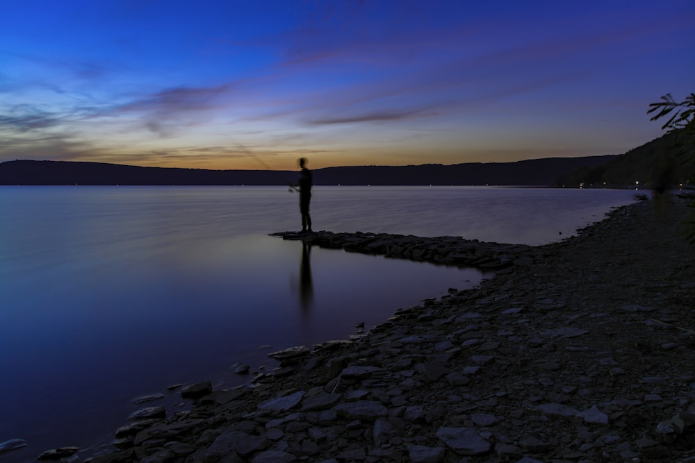 man standing on seashore