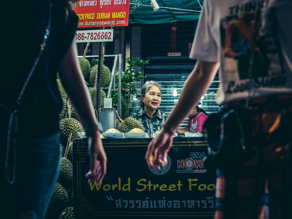 woman selling street food at night