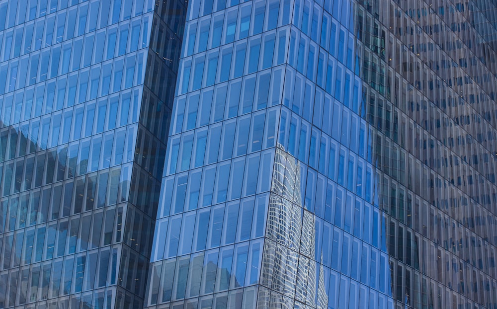low-angle photography of blue glass walled high-rise building