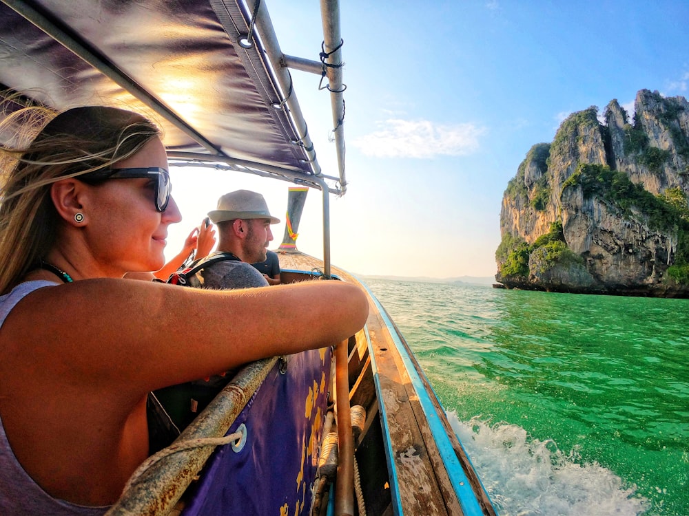 man and woman riding on boat