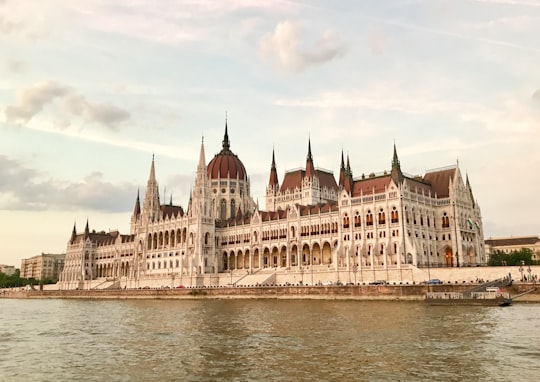 Hungarian Parliament Building in Budapest Hungary under white and blue sky in Shoes on the Danube Bank Hungary