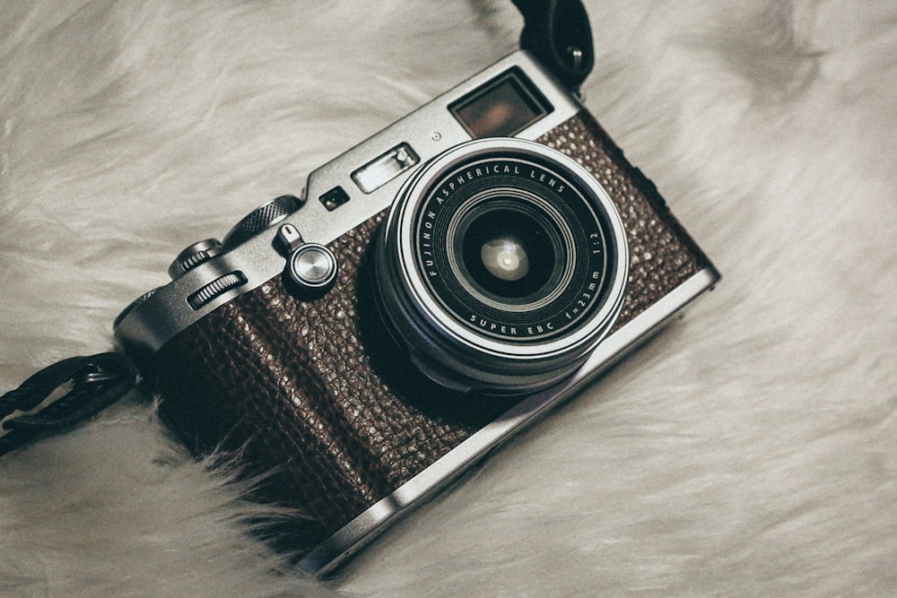 a camera sitting on top of a white fur covered floor