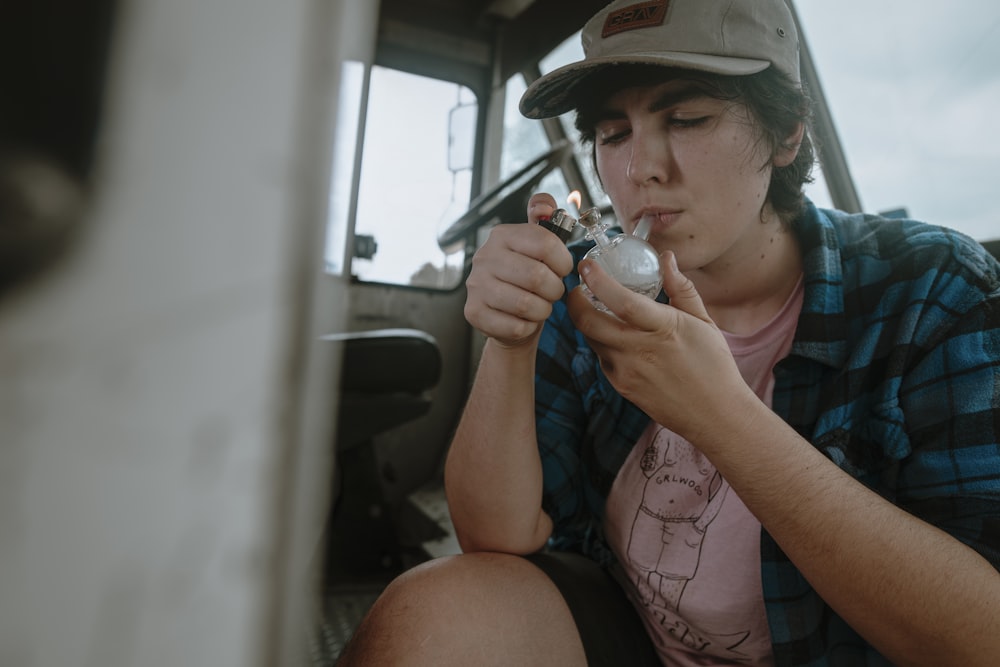 man holding glass meth pipe