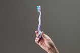 purple, green, and white toothbrush