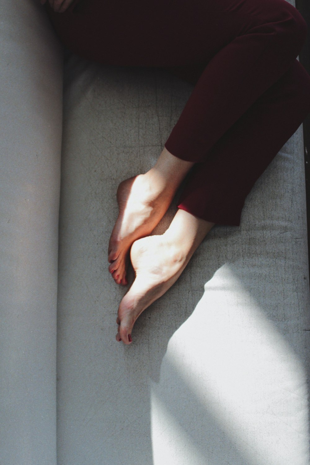 person's feet lying on couch