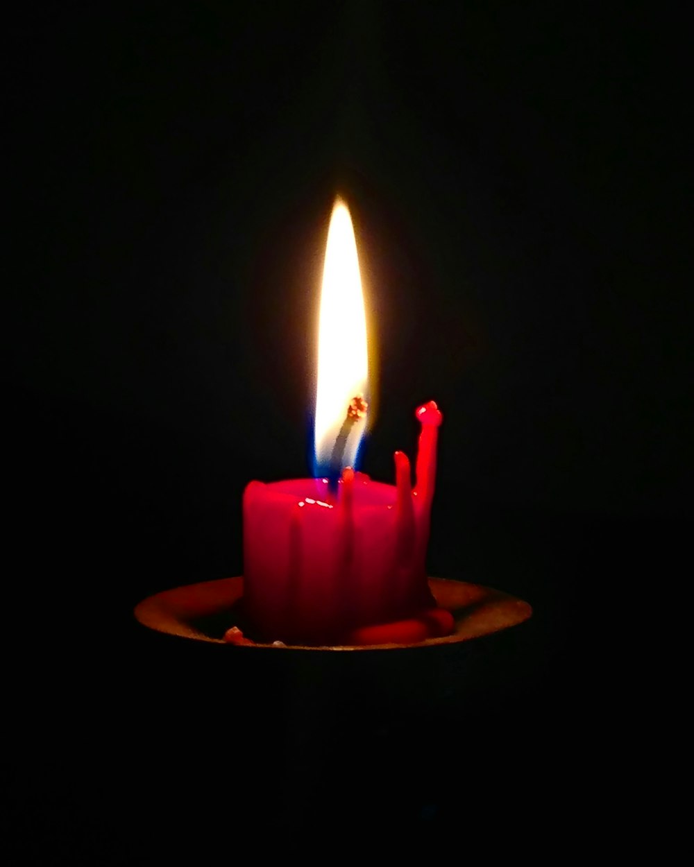 red candle on tabletop