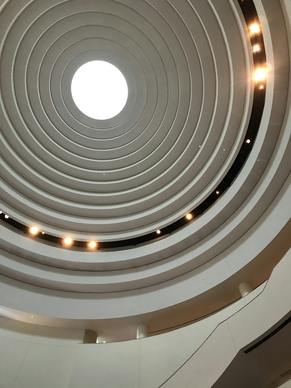 a circular ceiling with lights in a building
