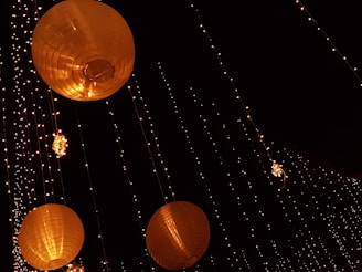 Festive garden lights glowing warmly across a backyard in the evening.