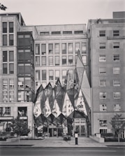 A commercial building with a unique facade and landscaping.
