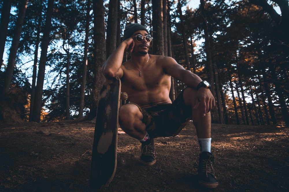 man sitting on the air leaning on the surfboard on forest