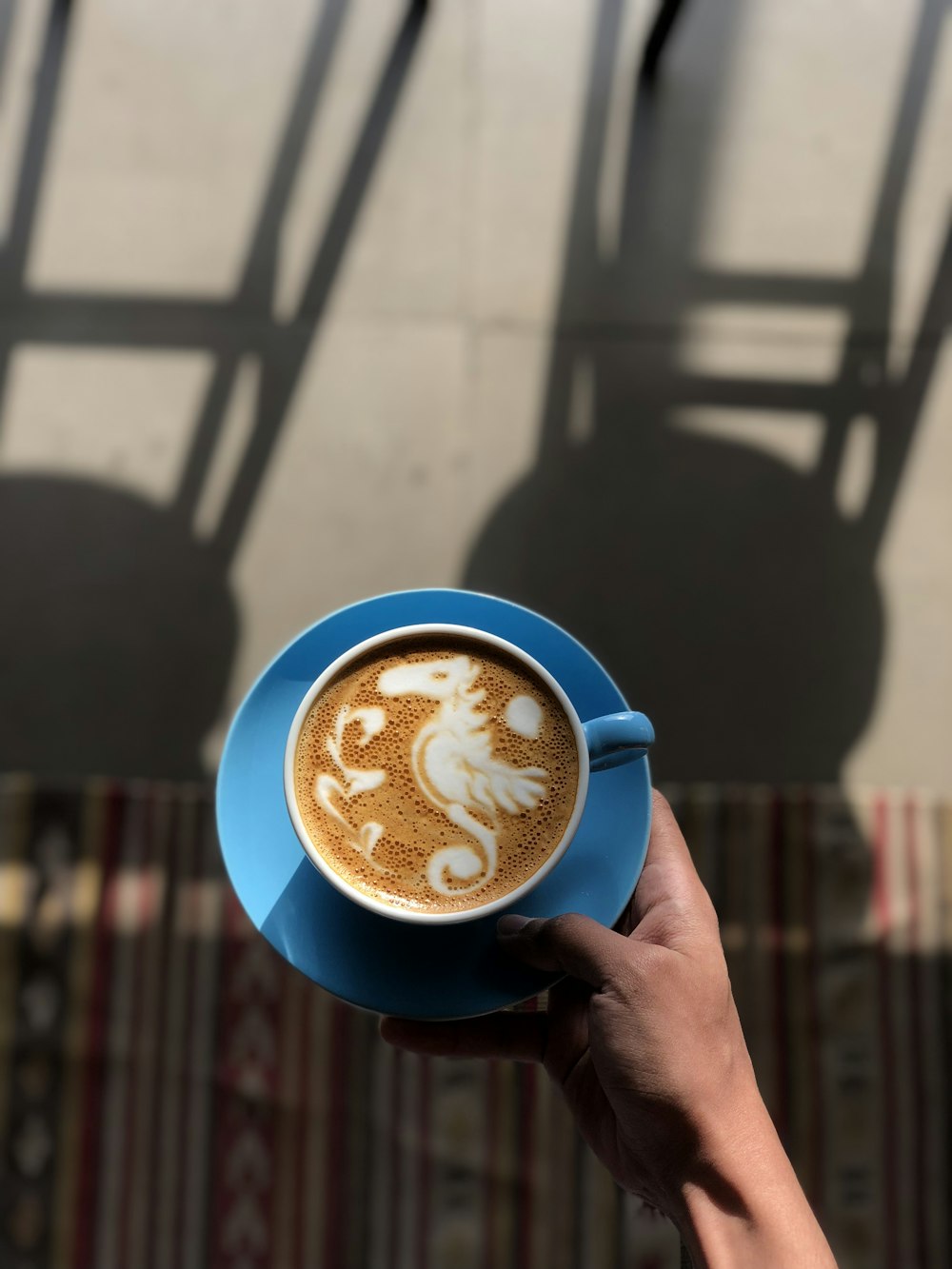 person holding ceramic mug