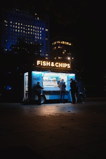 group of people standing on Fish & Chips store