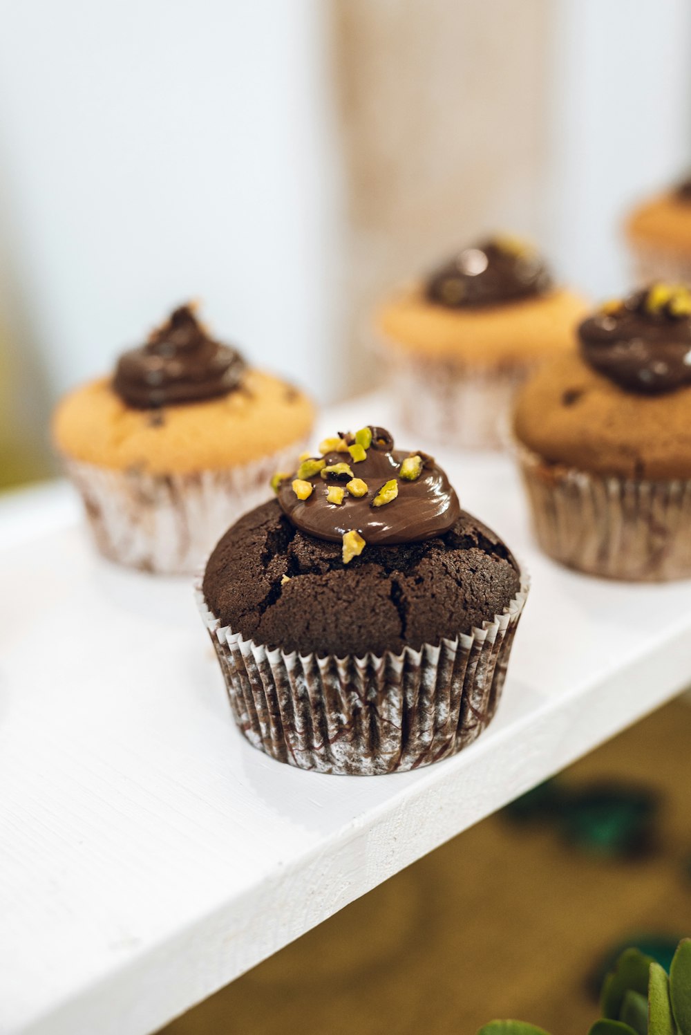 chocolate cupcake with yellow icing on white ceramic plate