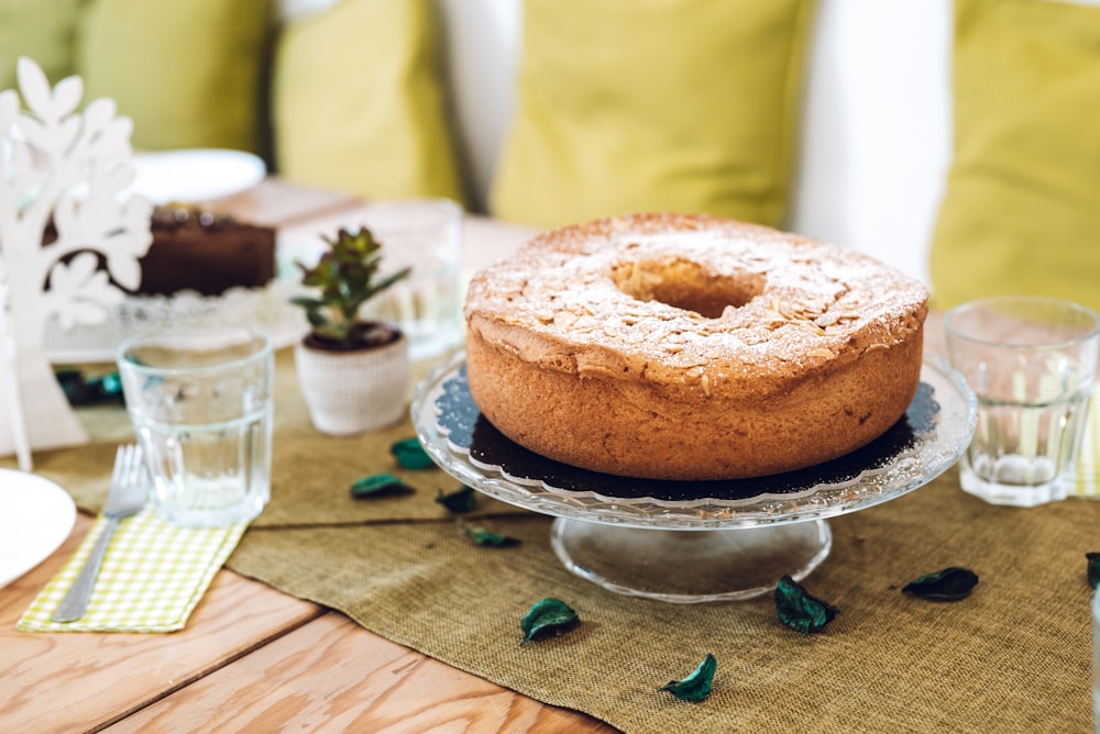 cake on stand beside cup