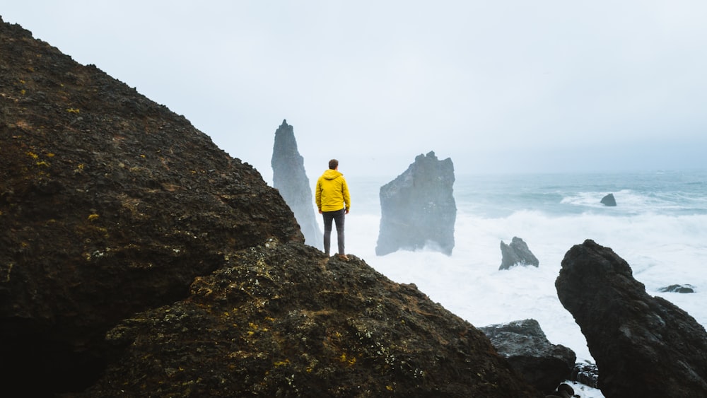 man standing on rock formation