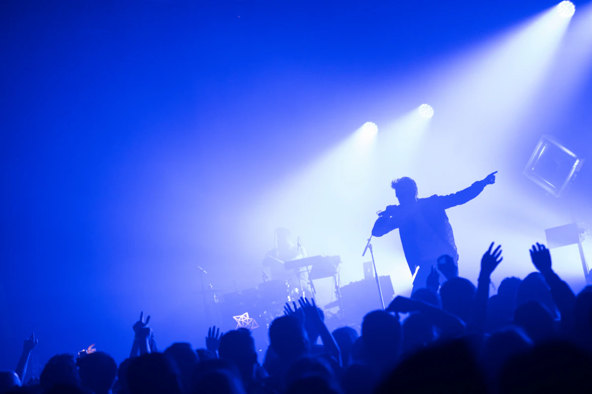 Performer on stage in front of a crowd