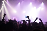 A diverse group of customers happily using mobile tickets at a venue.