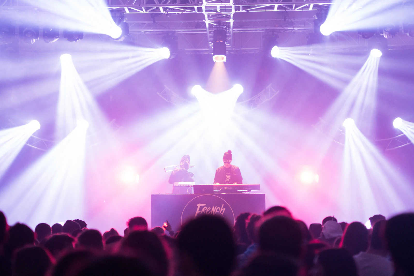 DJ playing to a crowd under stage lights