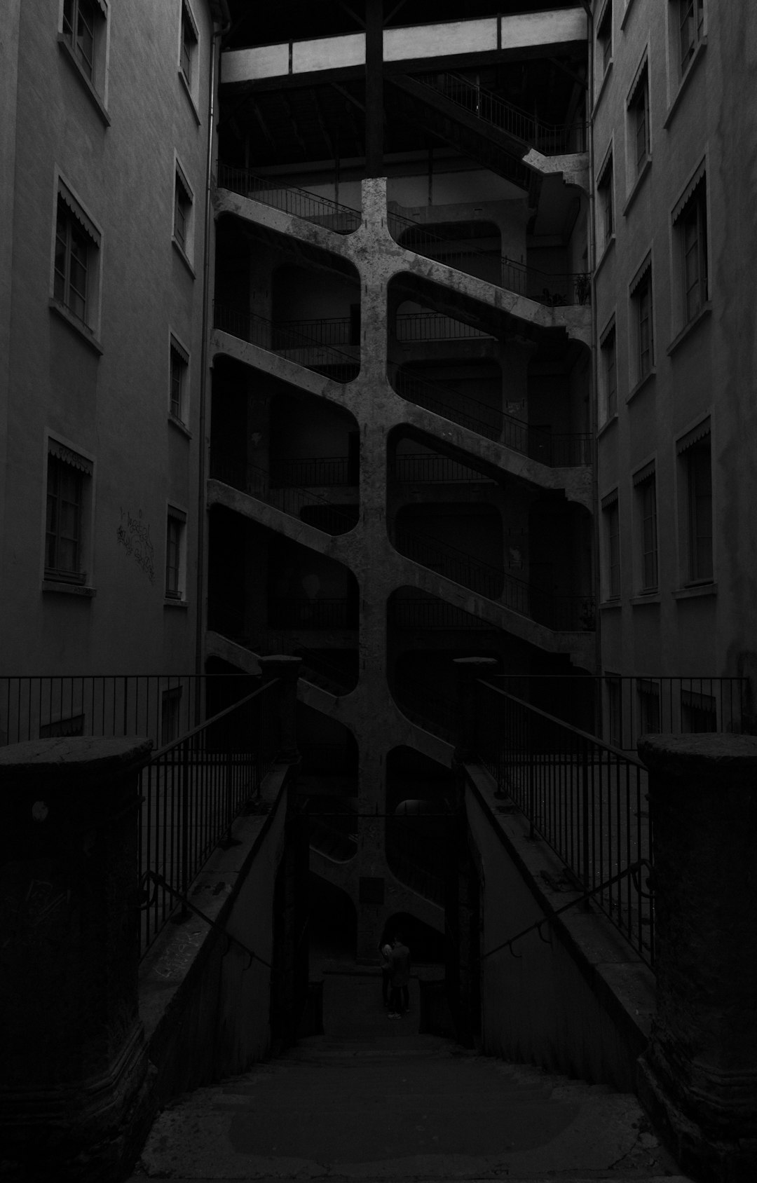 Traboule.

Among a handful of cities traversed by traboules, Lyon is the most famous for its own.

Traboules are hallways through private buildings which were usually used by silk manufacturers et al. to move their products while being sheltered from the weather caprices. Some are still open to the public a few hours a day... if one dares to push a few closed doors to find them.

You can read more about this on Wikipedia: https://en.wikipedia.org/wiki/Traboule