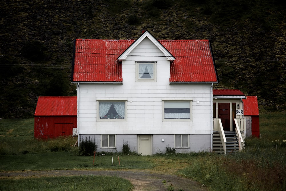 white and red 2-storey house near trees