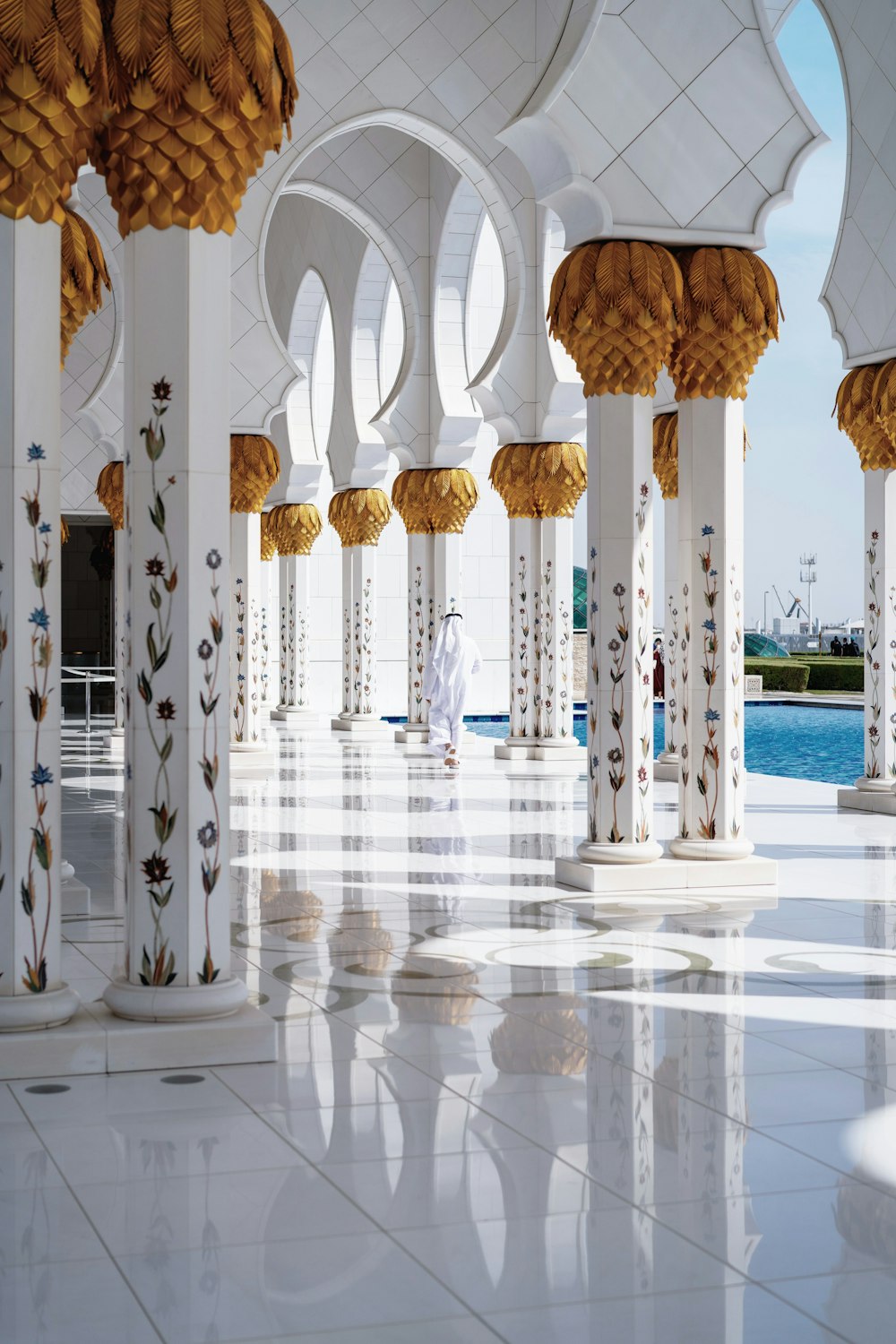 white and gold temple beside pool