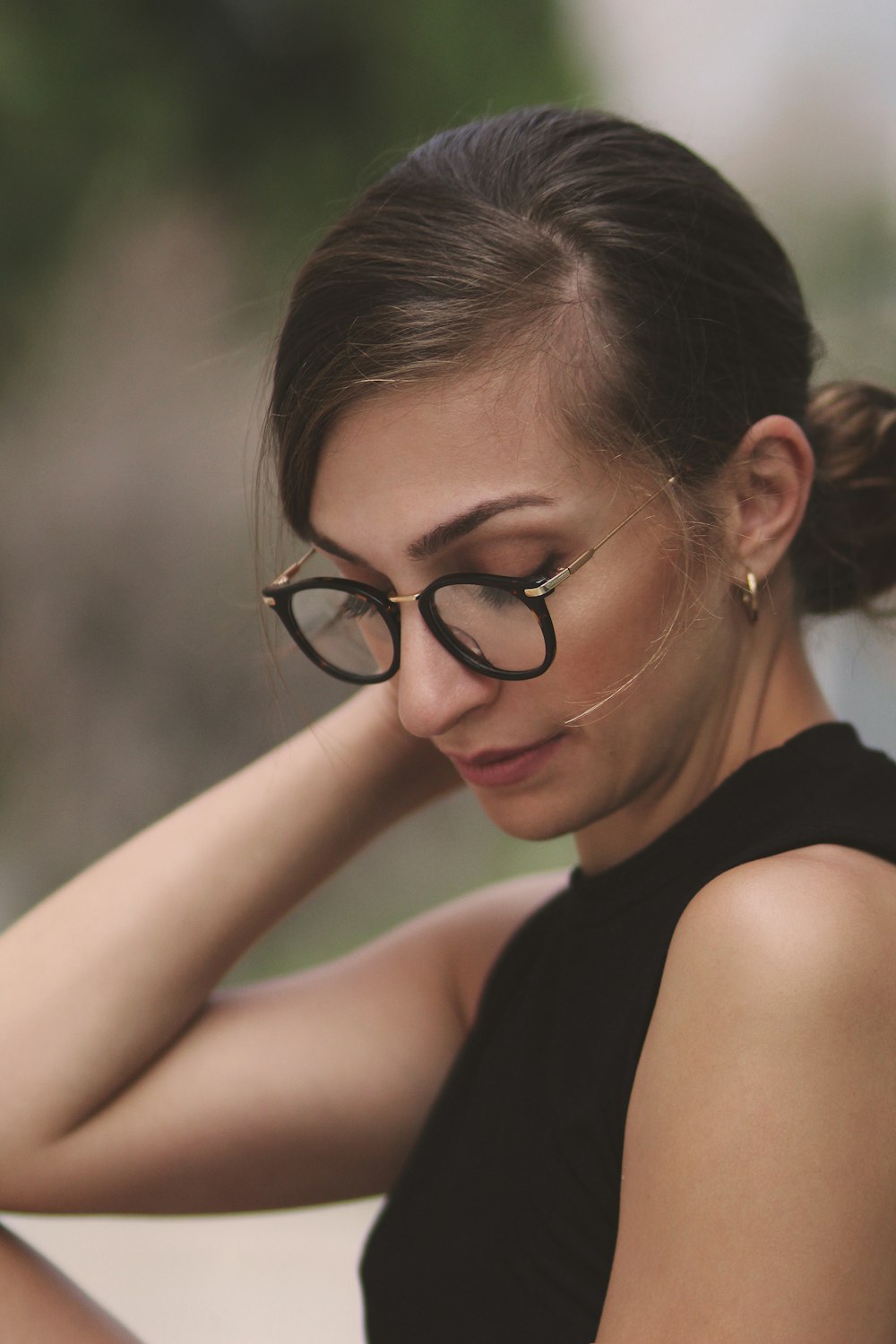 woman in black top with eyeglasses