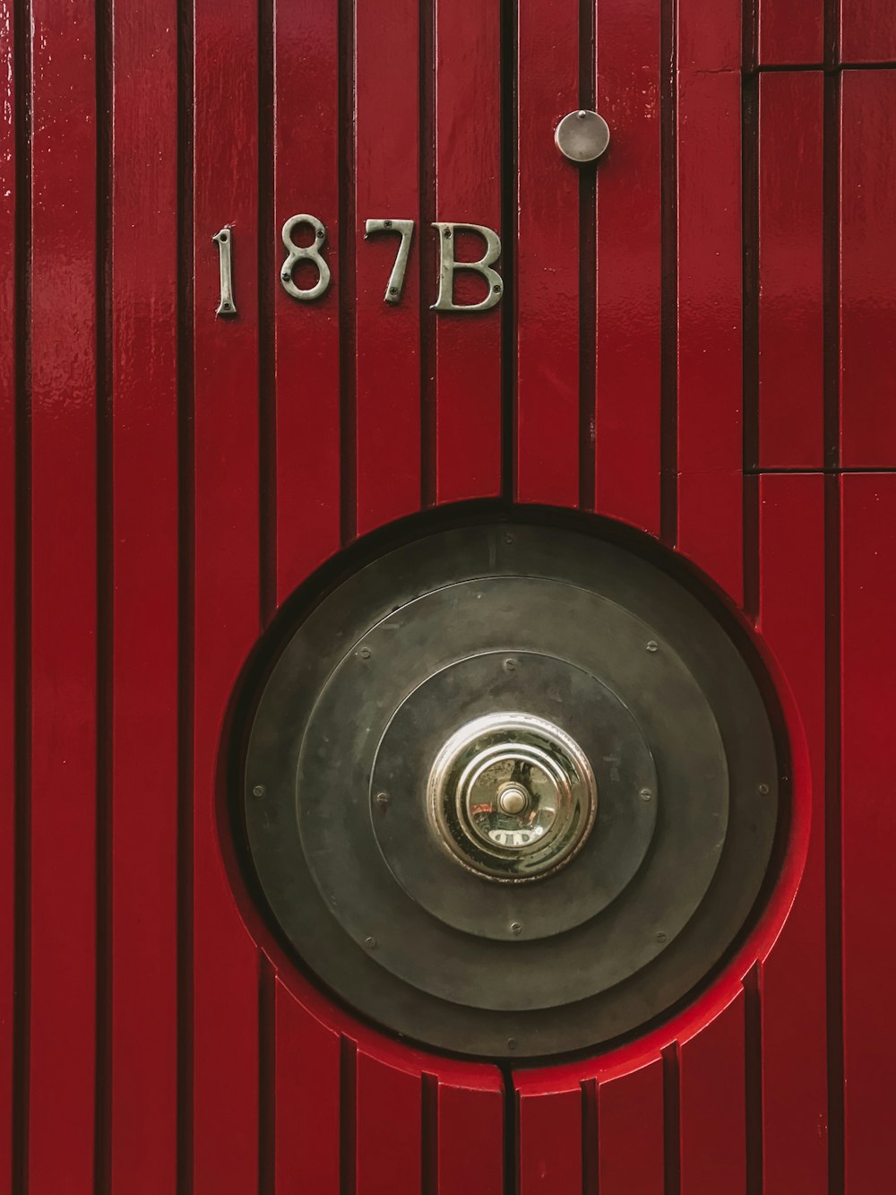 a close up of a red door with a metal knob