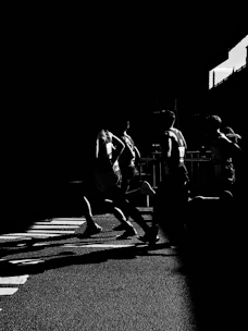 grayscale photo of people walking on street
